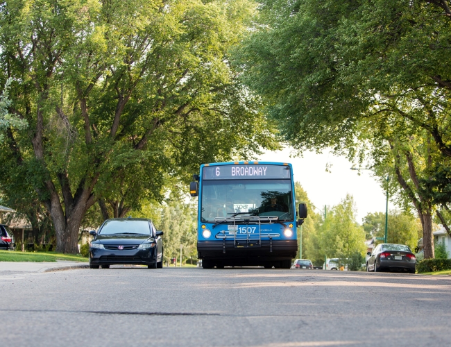 A public transit bus driving down the street. The sign