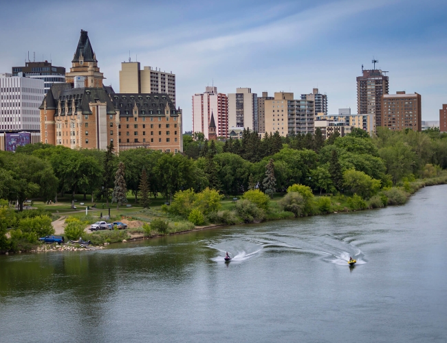 two individuals using jetskis on the South Saskatchewan River