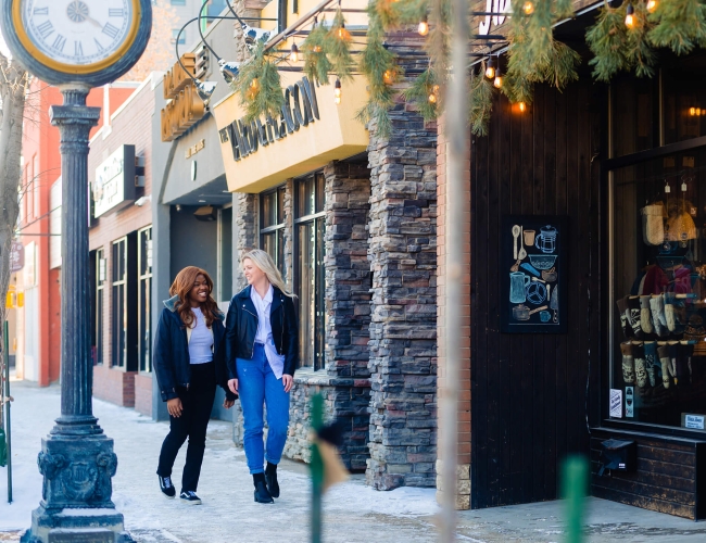 two woman walking down the street