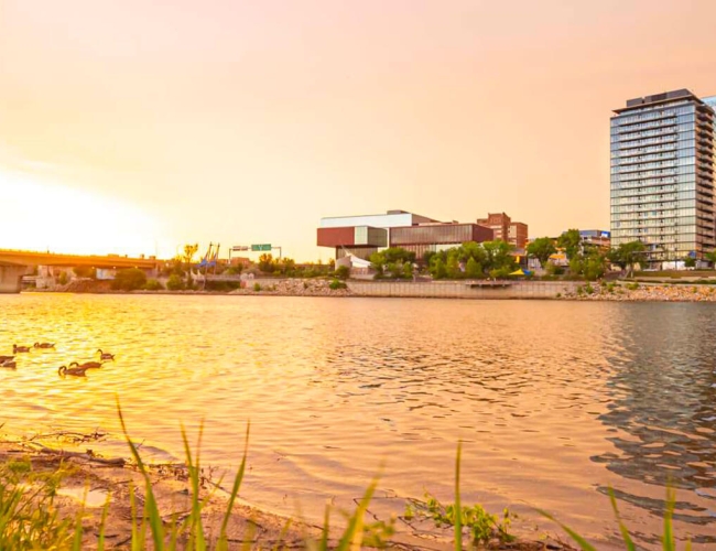 The city of Saskatoon as seen from across the water at sunrise