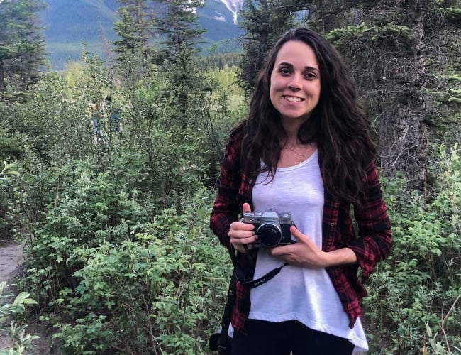 woman with camera in nature 