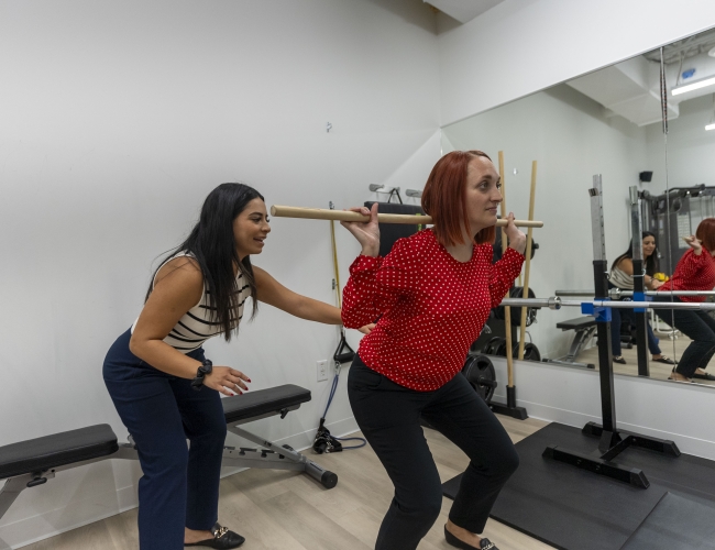 Women exercising in a gym, fitness training.