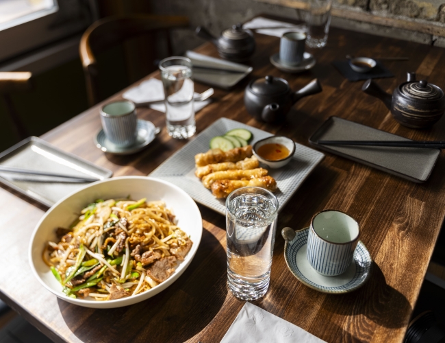 A table with bowls of food and utensils arranged neatly