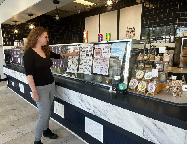 Person pointing at a menu