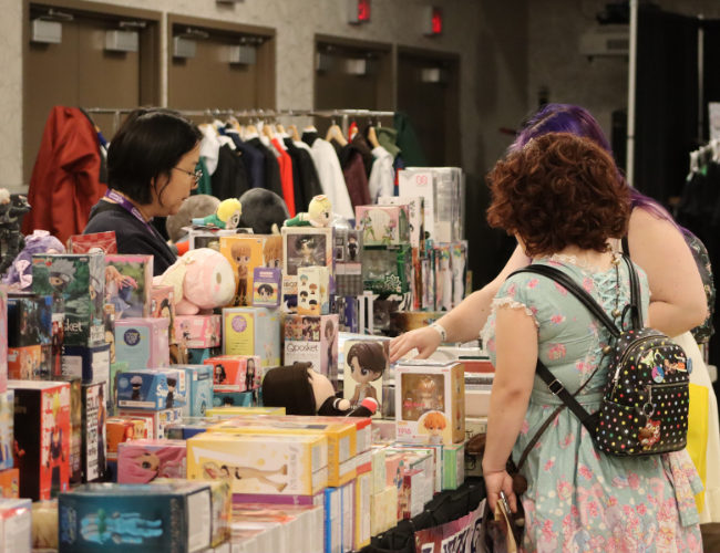 People shopping at a vendor booth at Ganbatte