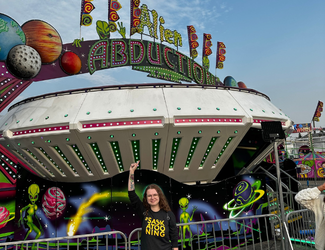 Person standing in front of Alien Abduction