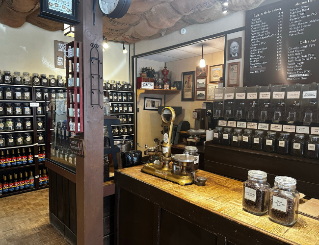 A coffee boutique with jars of coffee, tea, and syrup