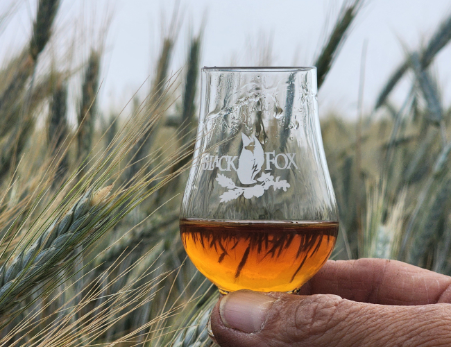 Glencairn filled with whisky held in the triticale grain field