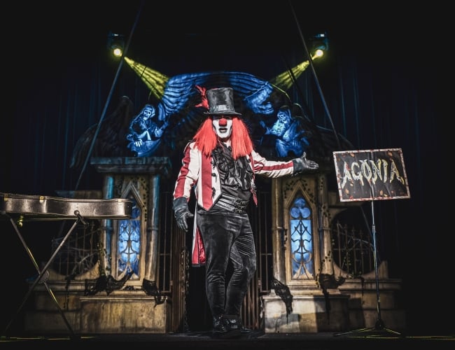 Photo of an actor dressed as a vampire clown on stage