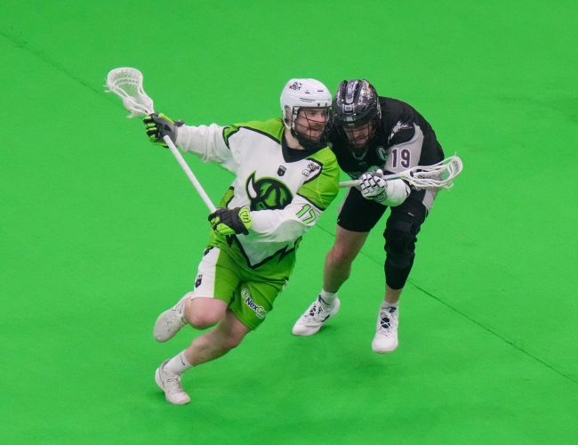 Sask Rush Player takes on Calgary Defender