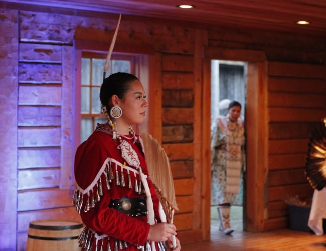 Indigenous dancer on stage in a heritage site 