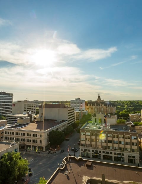 Aerial view of the city of Saskatoon with a blue sky and buidings