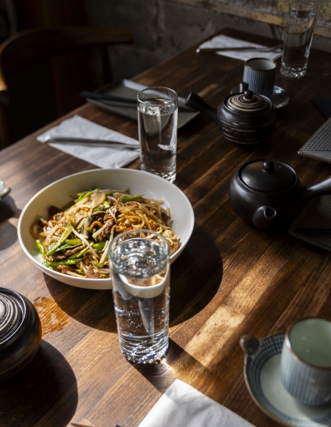 A table with bowls of food and utensils arranged neatly