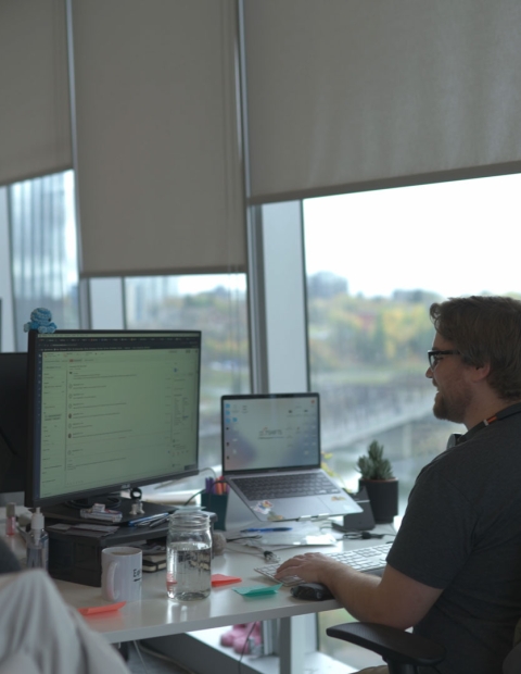 two people working at a desk at 7 Shifts