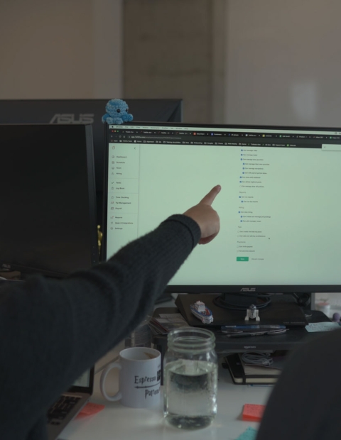 Two people looking at a document on computer at 7 Shifts