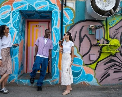 people standing looking at murals